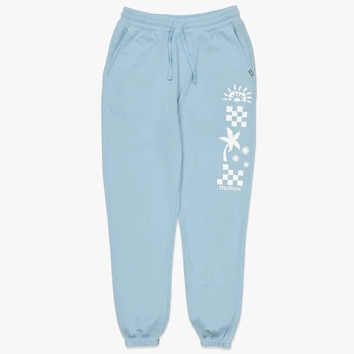 Billabong Girls Making Waves trackpants in bliss blue, with a white graphic print on the right leg, laid flat.