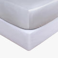 Cotton Co 400 Thread King Fitted Sheet set, featuring a silver sheet stacked on a white sheet, displaying smooth fabric.