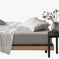 Silver Cotton Co 400 Thread Queen Extra Fitted Sheet, shown on a bed with white bedding and a side table.