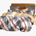 Cotton Co Amsterdam T200 Super King Duvet Cover set featuring a grey, white, red, and beige plaid pattern on a made bed.