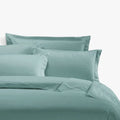 Duck egg blue Egyptian cotton 400 thread count king size duvet cover set with matching pillowcases, neatly arranged on a bed.
