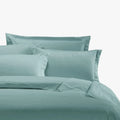 Duck egg blue Egyptian cotton 400 thread count Queen duvet cover set, including folded duvet and pillowcases on a bed.