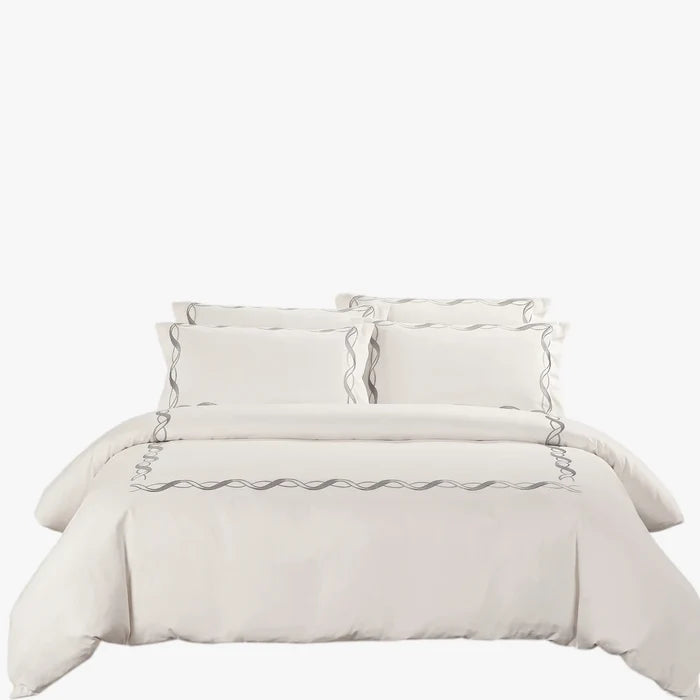 Cotton Co Opulence Antalia King 300 thread count duvet cover set in cream with grey wavy embroidery, arranged neatly on a