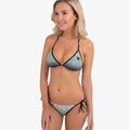 Blonde model wearing a Fox Womens Skarz Bikini with a black trim and green geometric pattern on both top and tie-side