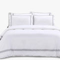 Giorgio Queen Duvet Cover T400 White on a bed with two pillows. The duvet cover features subtle grey stripe detailing at the