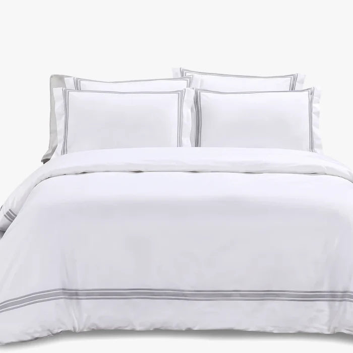 Giorgio Queen Duvet Cover T400 White on a bed with two pillows. The duvet cover features subtle grey stripe detailing at the