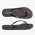 Two Holster women's black glitter holiday slops, also known as flip-flops, with sparkling rhinestone embellished straps,