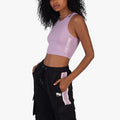 Sissy Boy Women's Sport Crop Racer Back Top in lilac, worn by a model, with black track pants featuring lilac stripes.