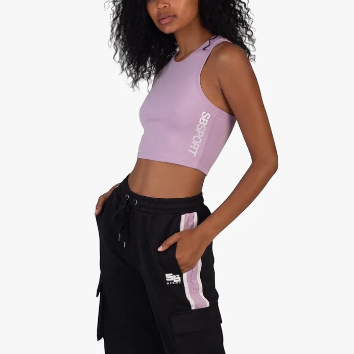 Sissy Boy Women's Sport Crop Racer Back Top in lilac, worn by a model, with black track pants featuring lilac stripes.