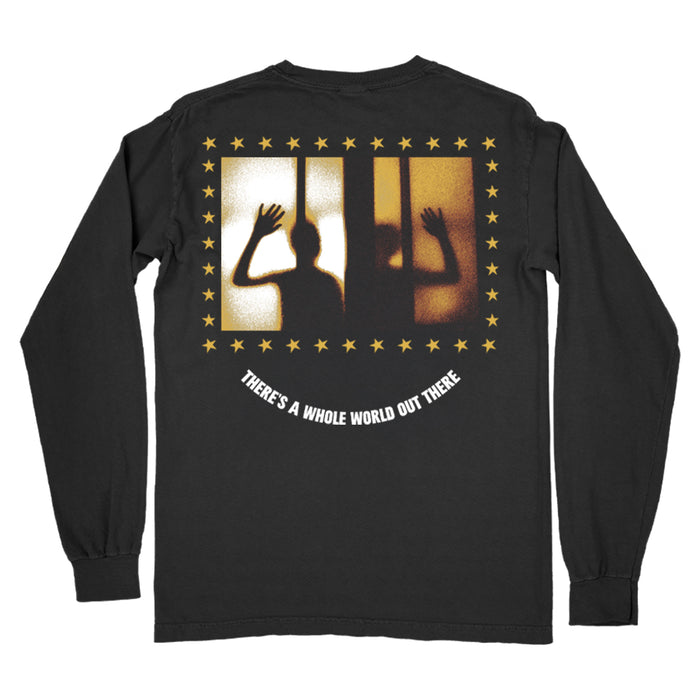 Arms Length black long-sleeve shirt featuring silhouetted figures behind bars framed by yellow stars, with the text “THERES A WHOLE WORLD OUT THERE.” below the graphic.